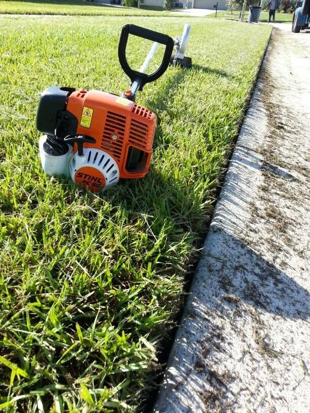 Edger along a clean lawn edge at the curb