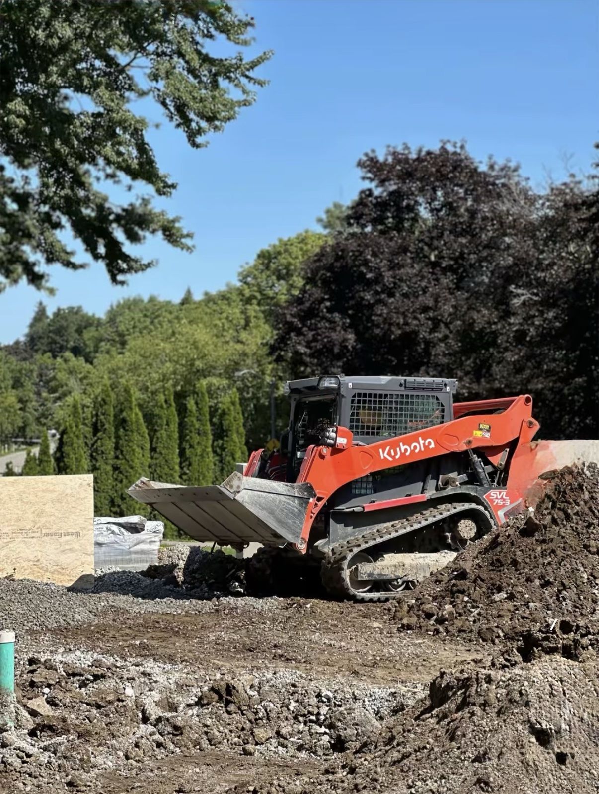 Track loader grading a construction site